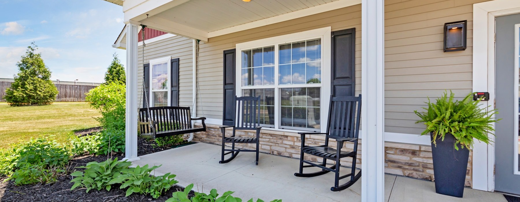a house with a patio and a patio with a table and chairs