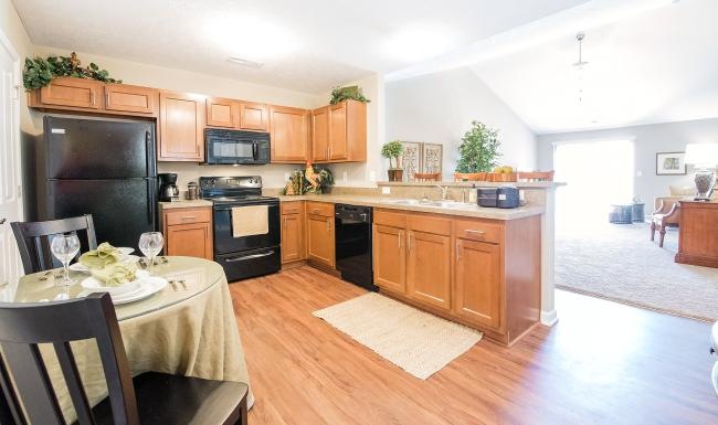 a kitchen with a table and chairs