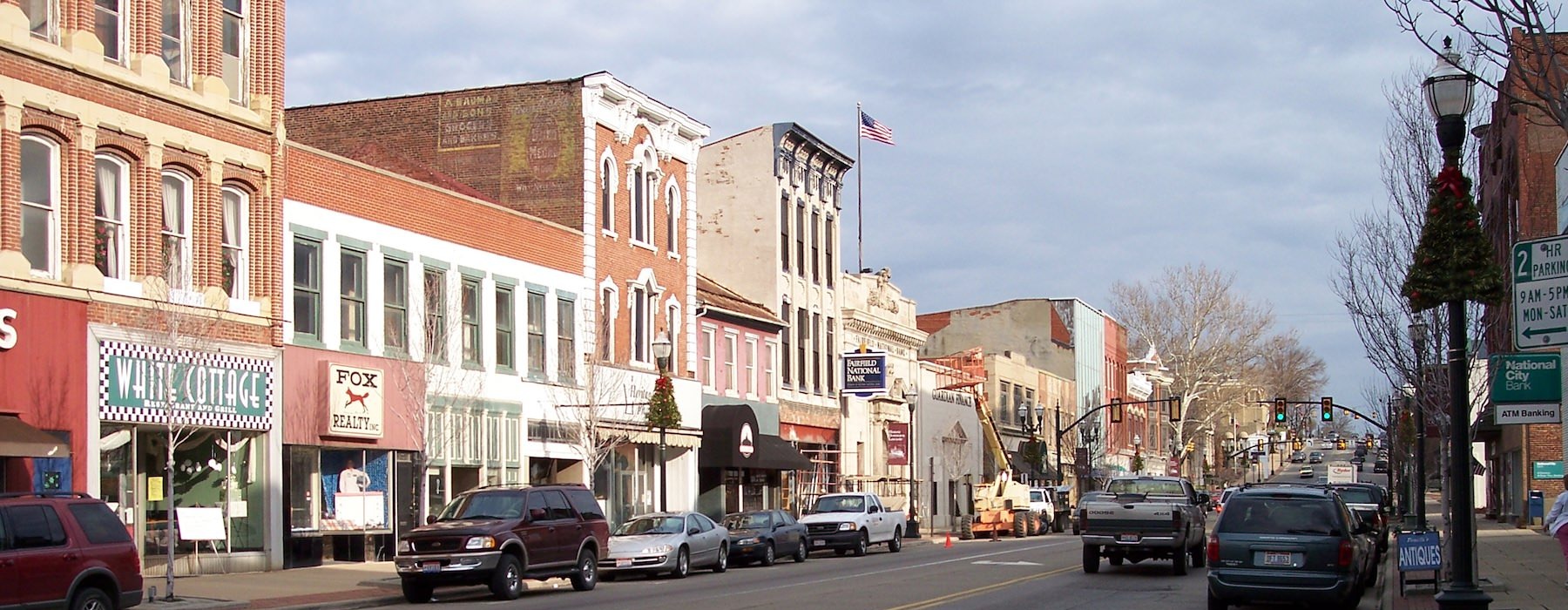 a street with cars and buildings along it
