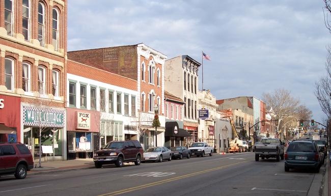 a street with cars and buildings along it